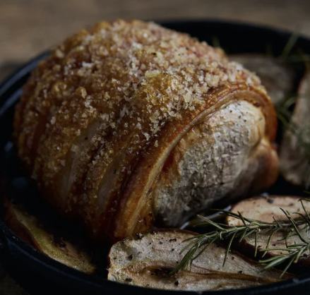 Boneless leg of pork with rosemary in a cast-iron pan