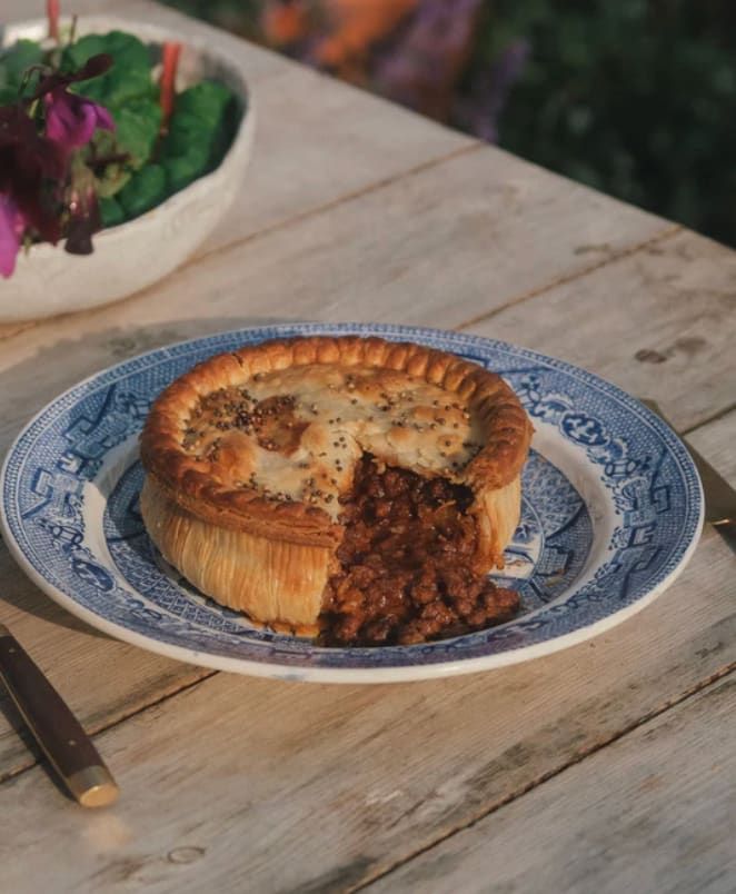 Grass-fed beef mince and onion pie on a blue willow plate